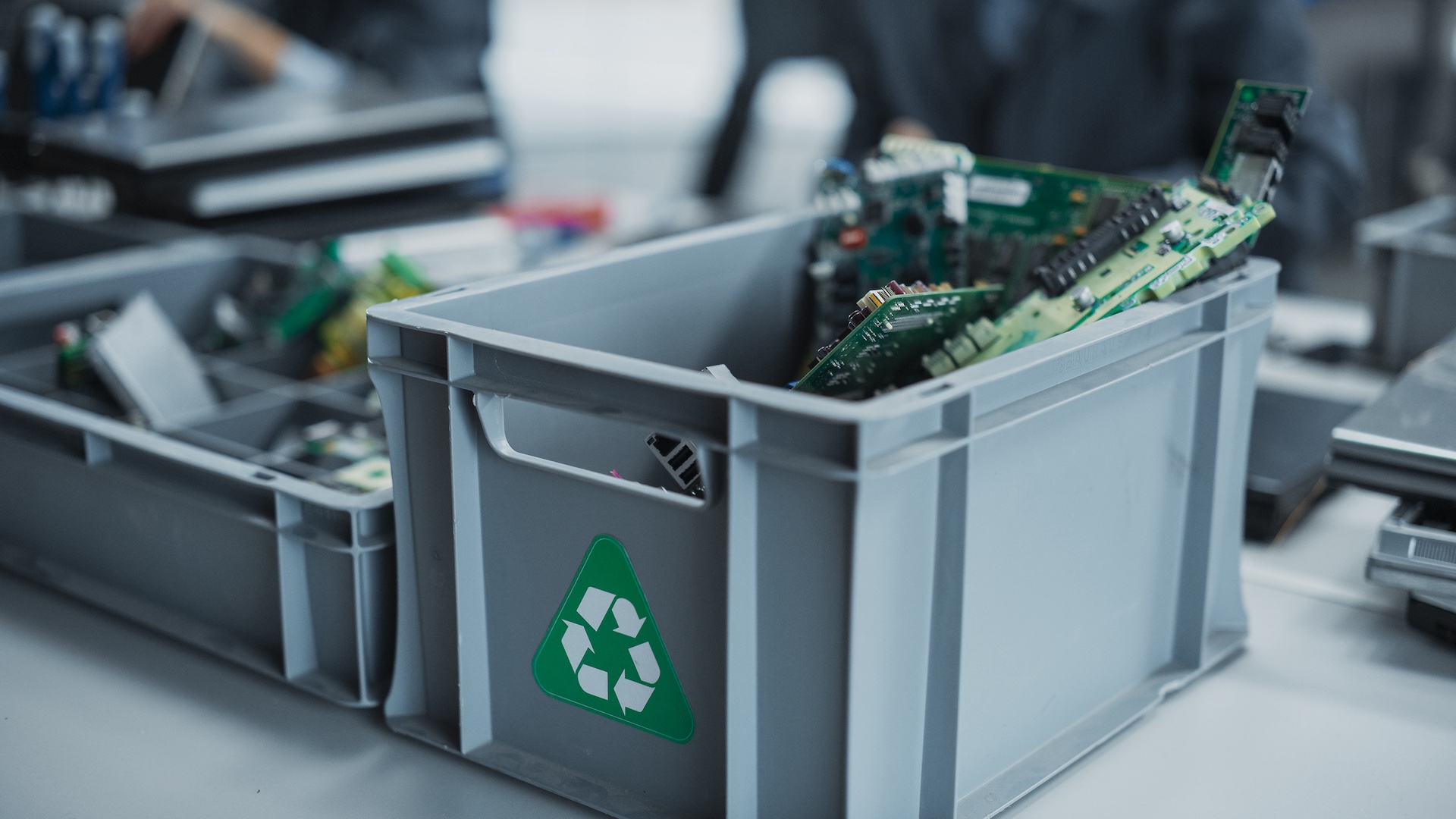 Close Up Shot Of Boxes With Computer Parts Sorted For Recycling At Sustainable Electronics Factory. Motherboards And Microchips Are Collected And Prepared For Reuse in Technological Devices.
